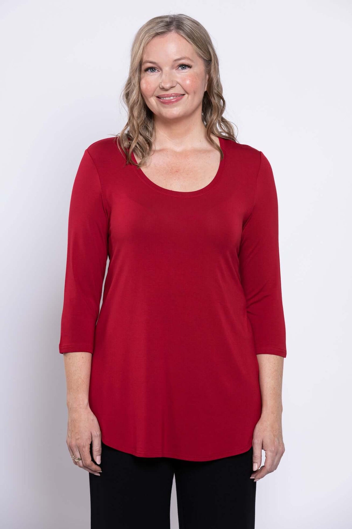 Front view of woman wearing a red 3/4 sleeve bamboo top