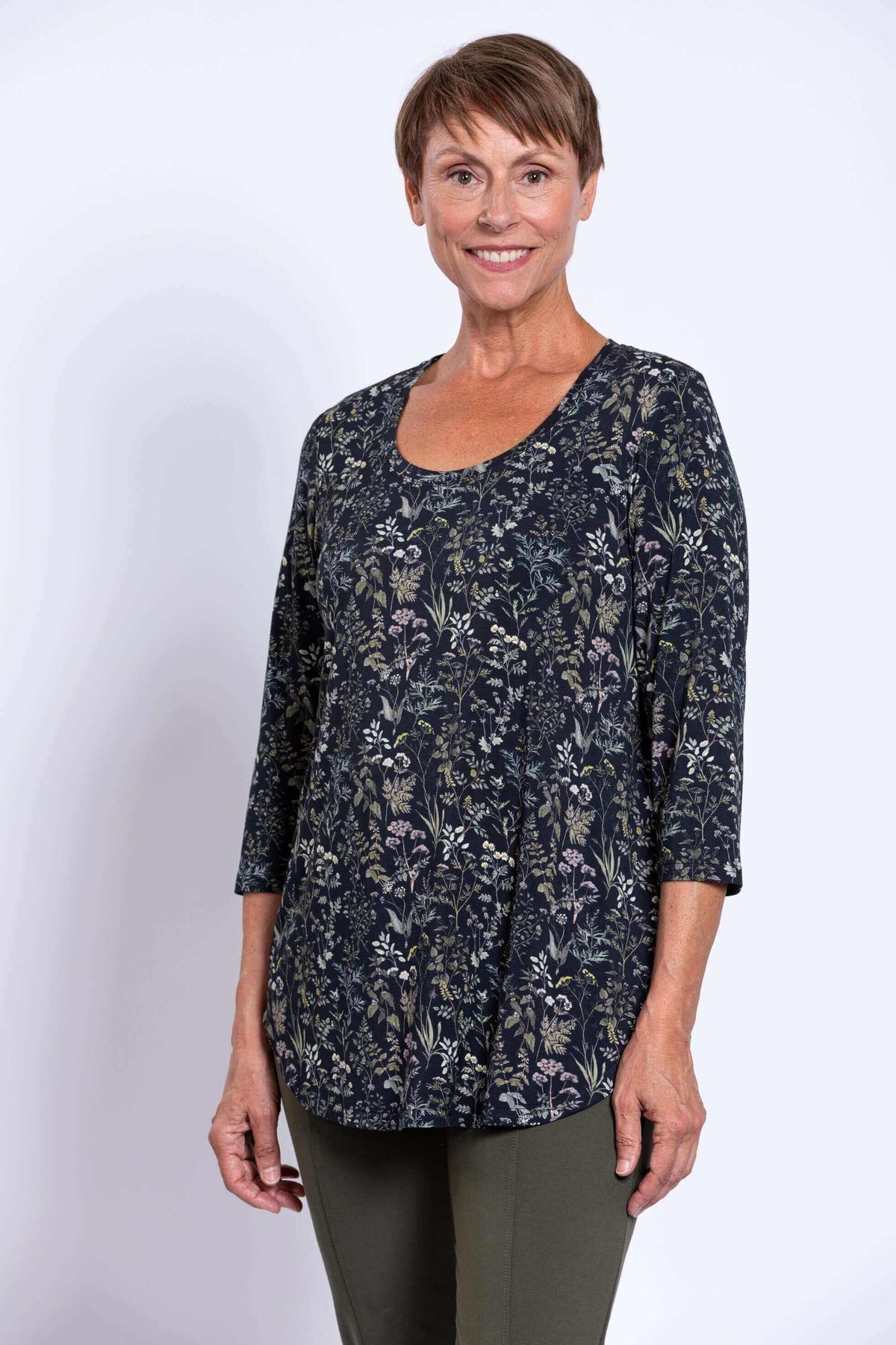 Side view of a woman in a black floral 3/4 sleeve bamboo top