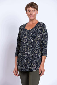 Side view of a woman in a black floral 3/4 sleeve bamboo top