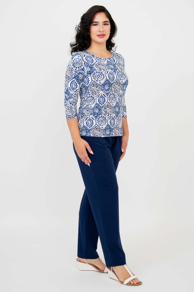 Side view of woman modeling blue mosaic print 3/4 sleeve tee