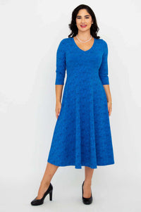 Woman wearing a royal blue midi dress with 3/4 sleeves and V-neckline standing front view