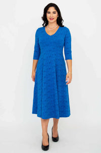 Woman modeling a royal blue midi dress with 3/4 sleeves and flared skirt, front view