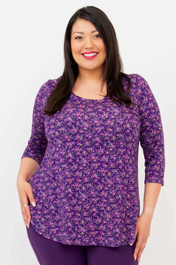 Woman modeling a violet floral 3/4 sleeve top, front view