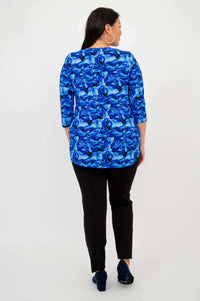 Back view of woman in blue abstract print 3/4 sleeve bamboo top and black pants