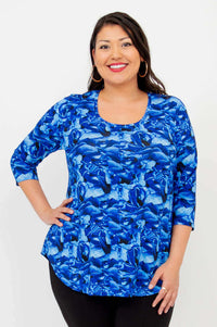 Woman wearing a blue abstract print 3/4 sleeve bamboo top, close-up view