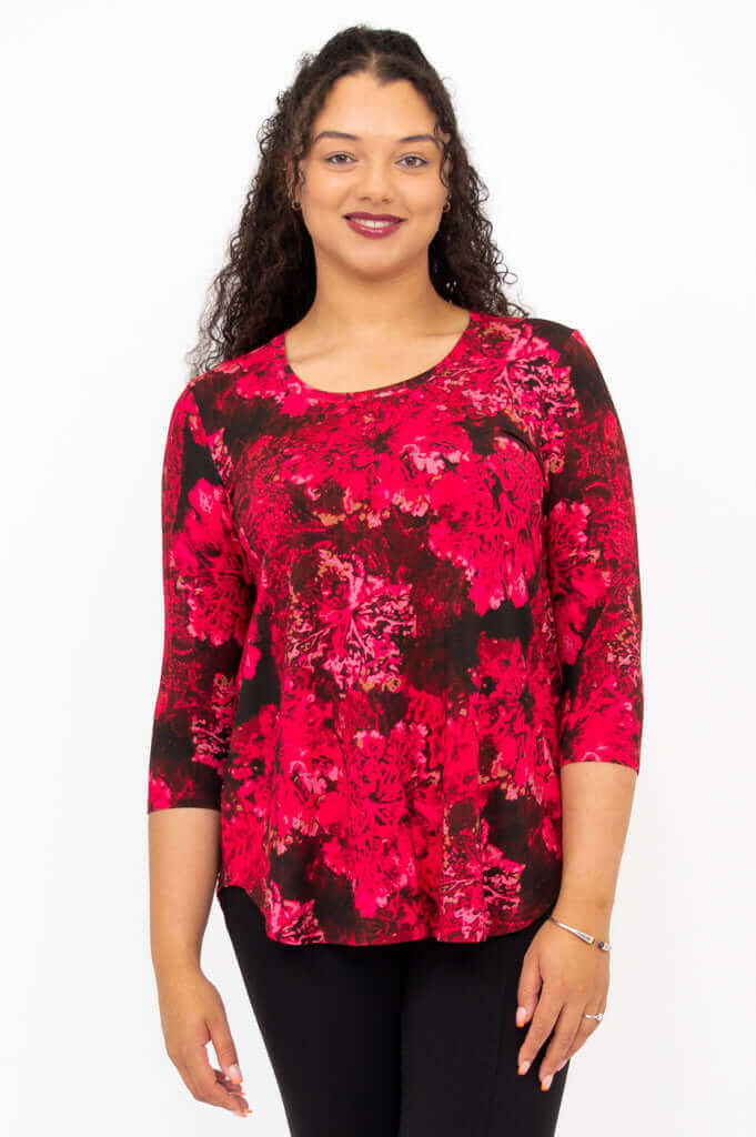 Front view of woman wearing a fuchsia swirl print 3/4 sleeve bamboo top