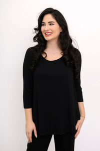 Woman wearing a black 3/4 sleeve bamboo top, looking to the side and smiling