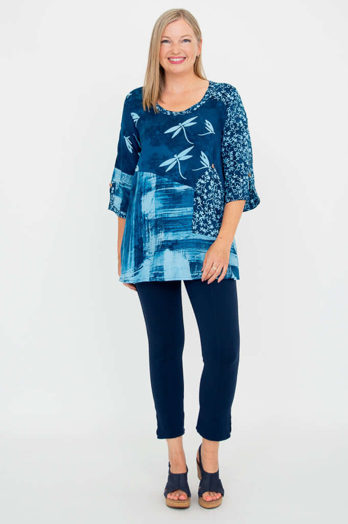 Full body shot of woman in blue 3/4 sleeve blouse and navy pants, front view