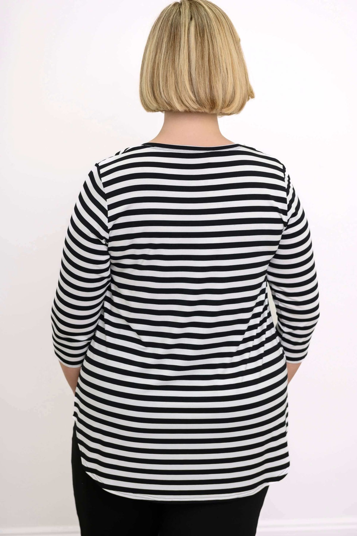 Back view of striped 3/4 sleeve top displayed on model