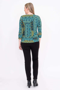 Back view of woman wearing blue and yellow patterned 3/4 sleeve tee with black pants