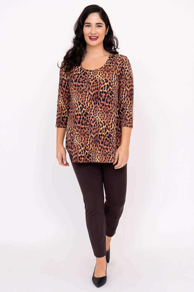 Full-length view of woman in a leopard print 3/4 sleeve top and dark pants