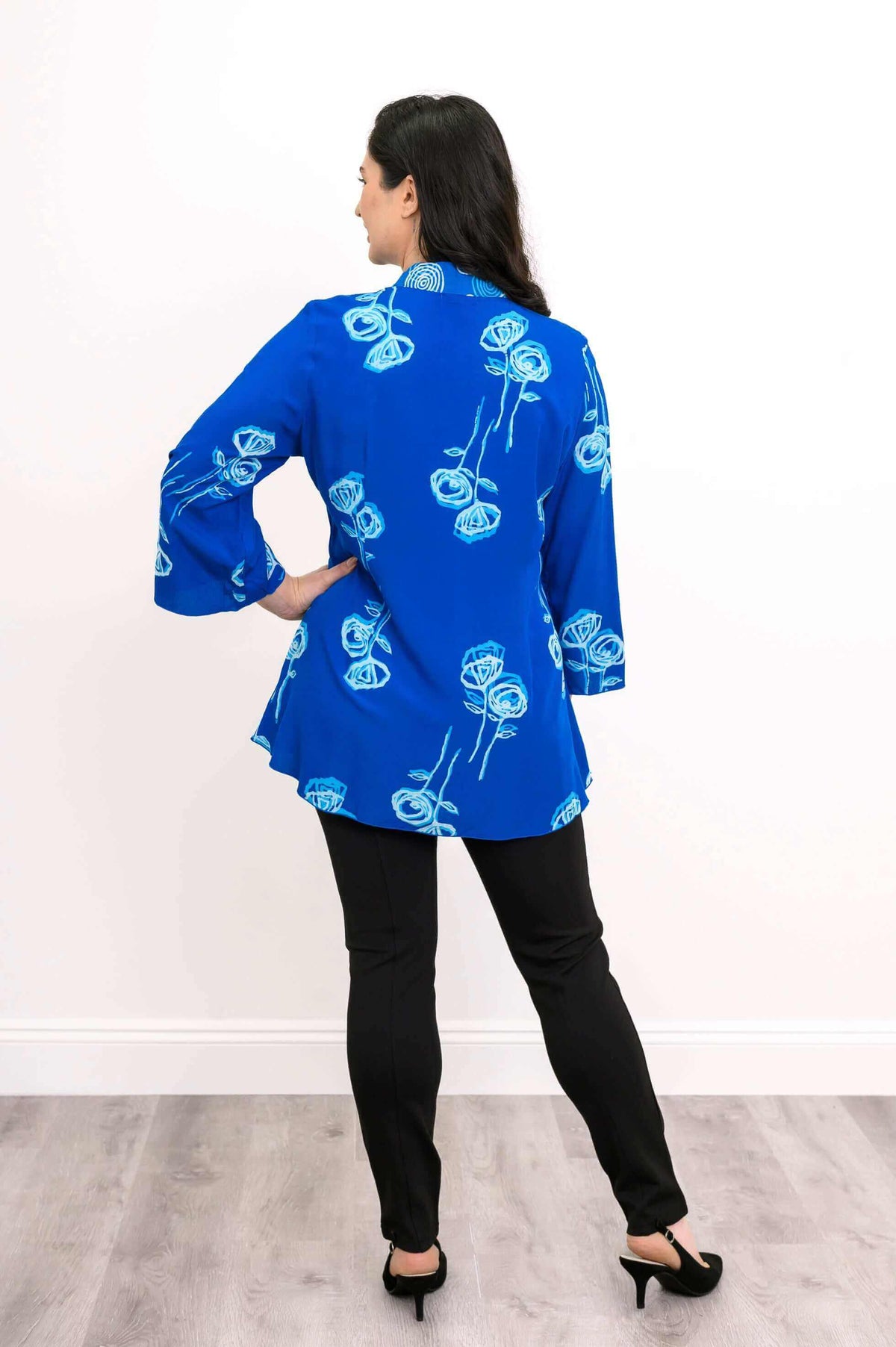 Back view of blue blouse with light blue floral print and mandarin collar