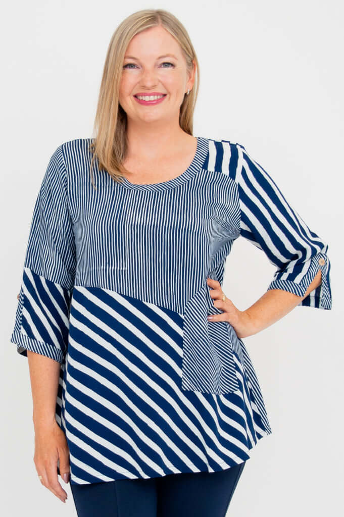 Woman wearing a navy and white striped blouse with a scoop neckline and 3/4 sleeves, front view