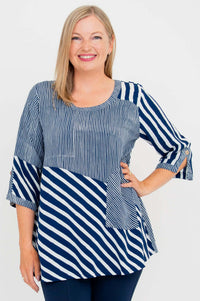 Woman wearing a navy and white striped blouse with a scoop neckline and 3/4 sleeves, front view