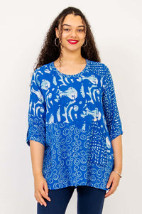 Front view of a woman wearing a blue batik-patterned Palace Blouse with scoop neckline and 3/4 sleeves