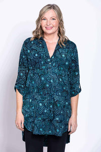 Woman wearing a blue batik patterned blouse with 3/4 sleeves and a V-neck