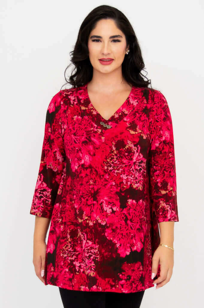 Front view of woman wearing pink floral Vana tunic with 3/4 sleeves