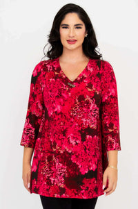 Front view of woman wearing pink floral Vana tunic with 3/4 sleeves