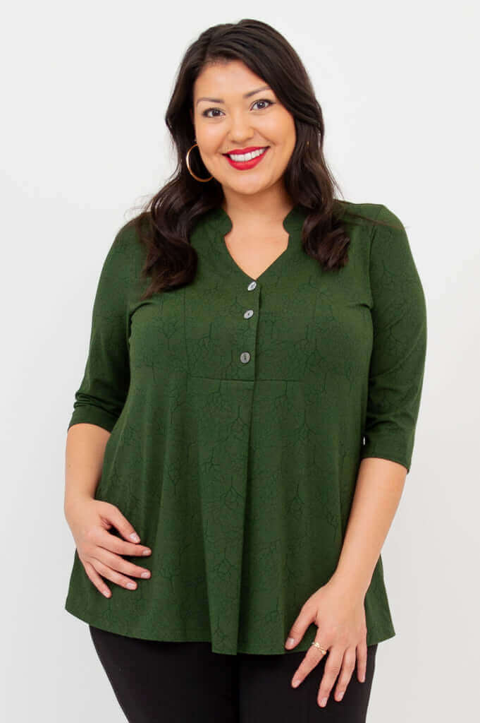 Woman wearing a green bamboo V-neck top with 3/4 sleeves, smiling