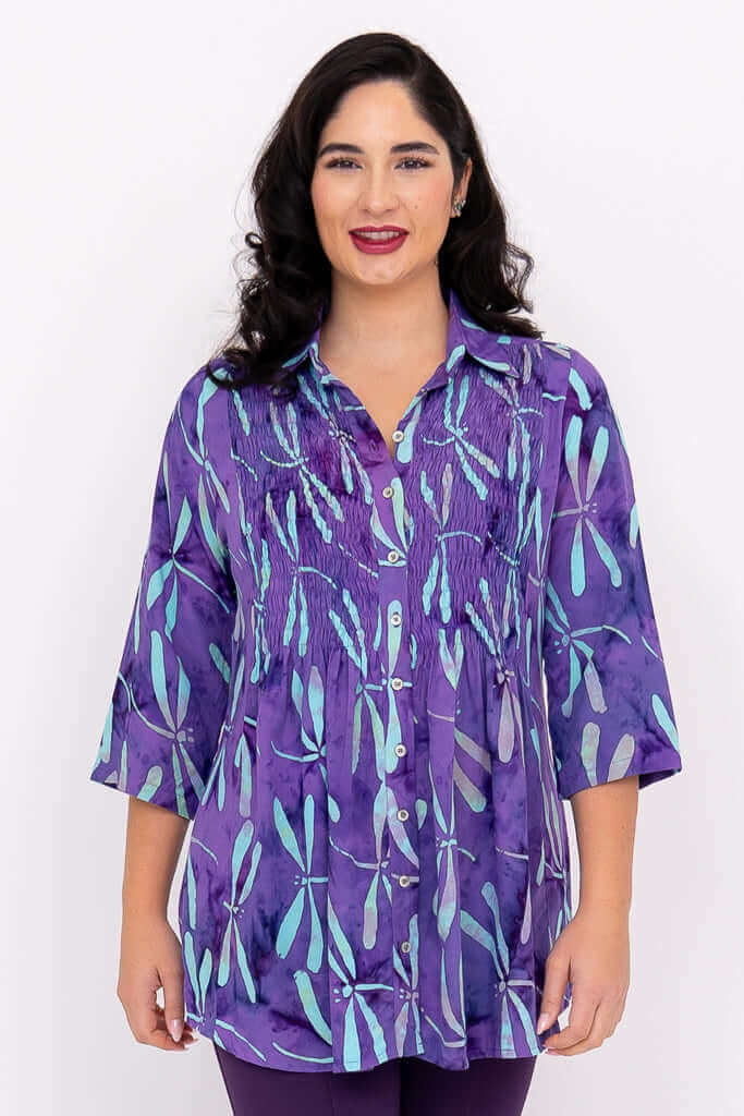Front view of woman wearing Cindy dragonfly violet tunic with smocked bodice and 3/4 sleeves