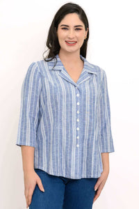 Woman wearing a blue and white striped button-up shirt with 3/4 sleeves, smiling at the camera