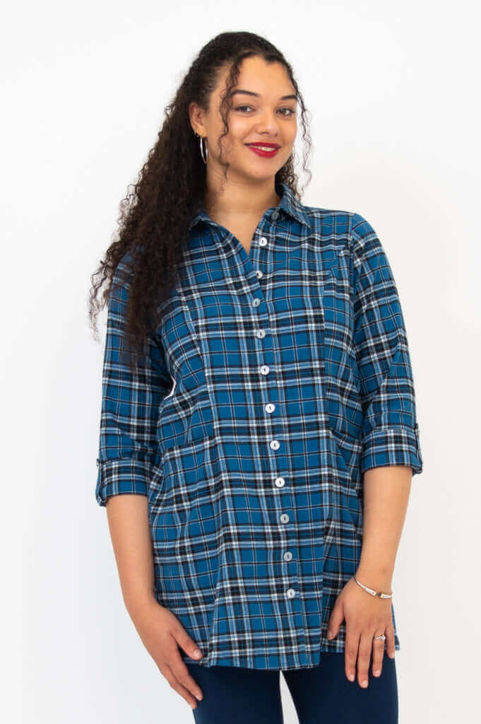Woman posing in blue plaid flannel tunic with tabbed 3/4 sleeves