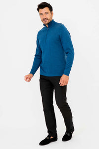 Side view of man in blue mock turtleneck sweater and black dress pants