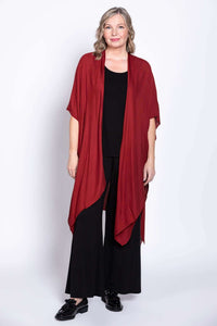 Angled front view of a woman in the Darcy kimono wrap in crimson