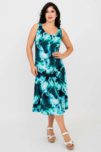 Front angled view of a woman in the aqua marble Evangelina tank dress with hand on hip