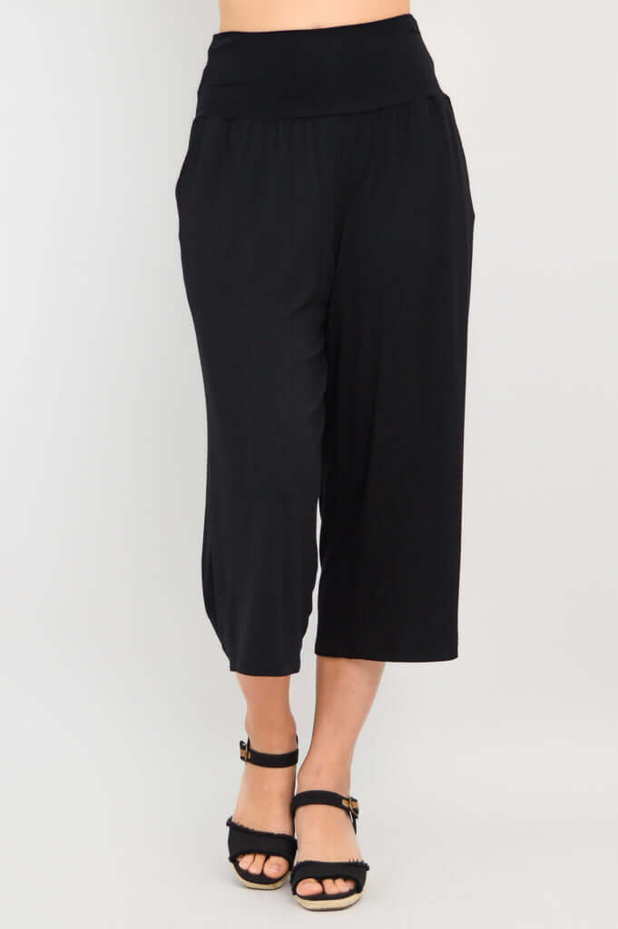 Angled view of black Gaylene capri pants showing relaxed fit