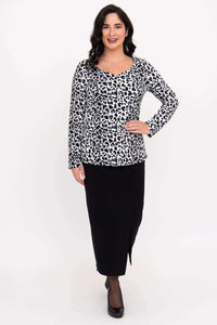 Full body front view of Annette long sleeve animal print top with black skirt