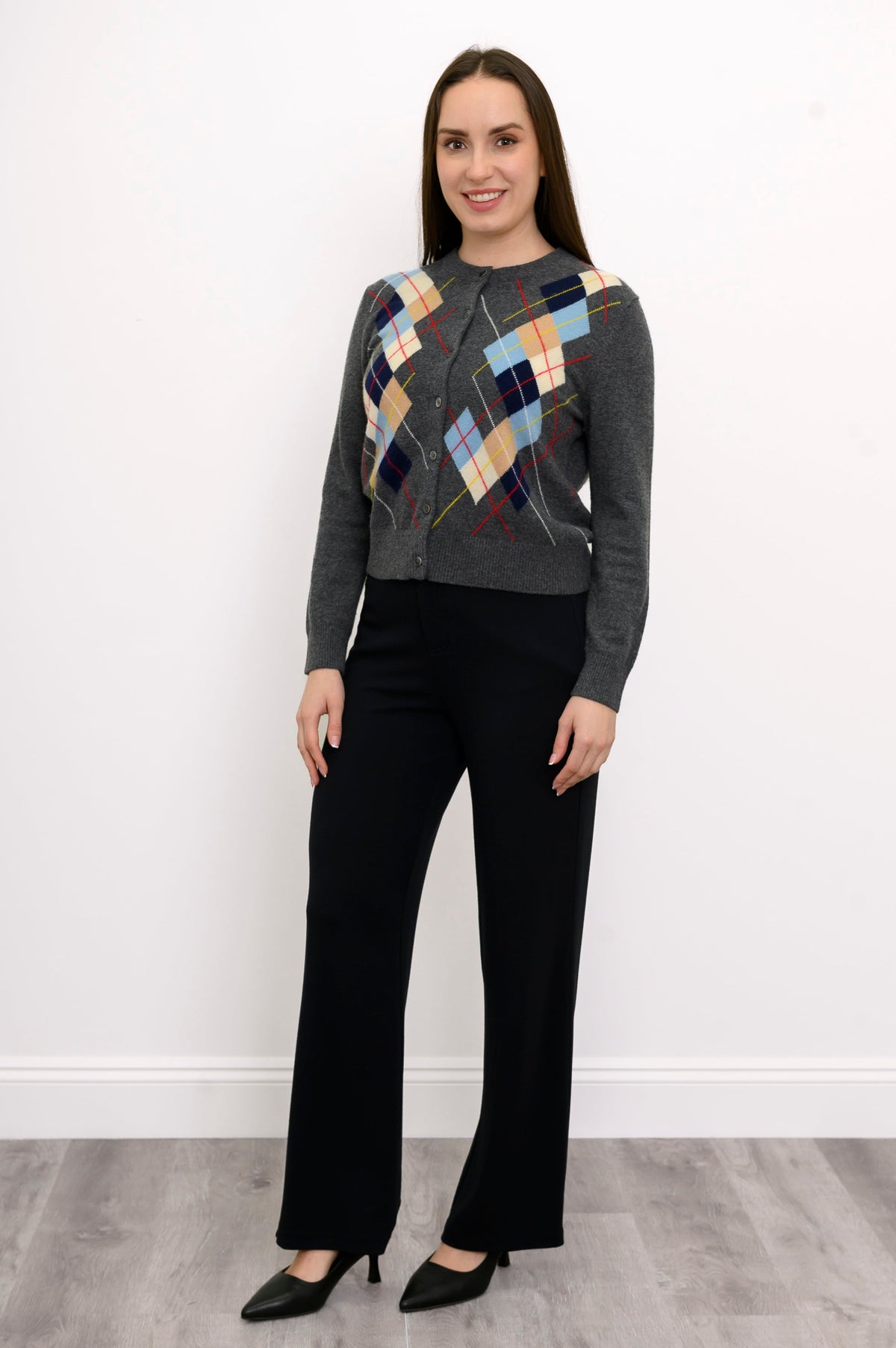 full body front view of woman in grey argyle cardigan with multicolor print