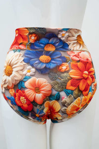 Back view of high waist brief featuring vibrant floral design on mannequin