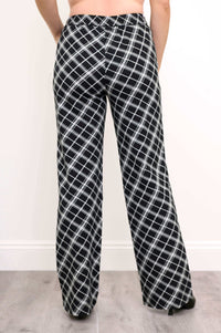 Back view of black and white plaid trousers with subtle pocket seams