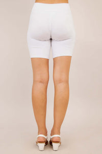 Back view of woman in white bamboo shorts with fitted appearance