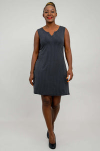 Back view of woman wearing a black and white pinstripe sleeveless shift dress
