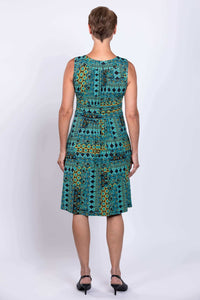 Back view of woman wearing sleeveless turquoise mosaic print dress