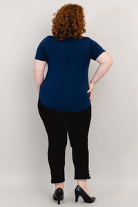 Back view of model wearing navy blue scoop neck short sleeve tee