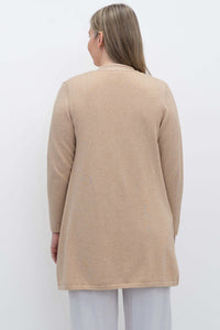 Back view of woman wearing a long sleeve beige open cardigan sweater