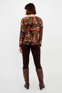 Back view of model wearing Mariah printed long sleeve tee and brown pants