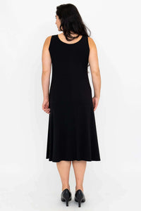 Back view of woman in sleeveless black A-line dress showing rear fit and length
