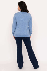 Back view of woman in light blue crew neck cardigan and navy pants