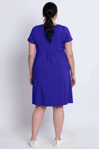 Back view of a woman wearing a royal blue bamboo dress highlighting the relaxed fit