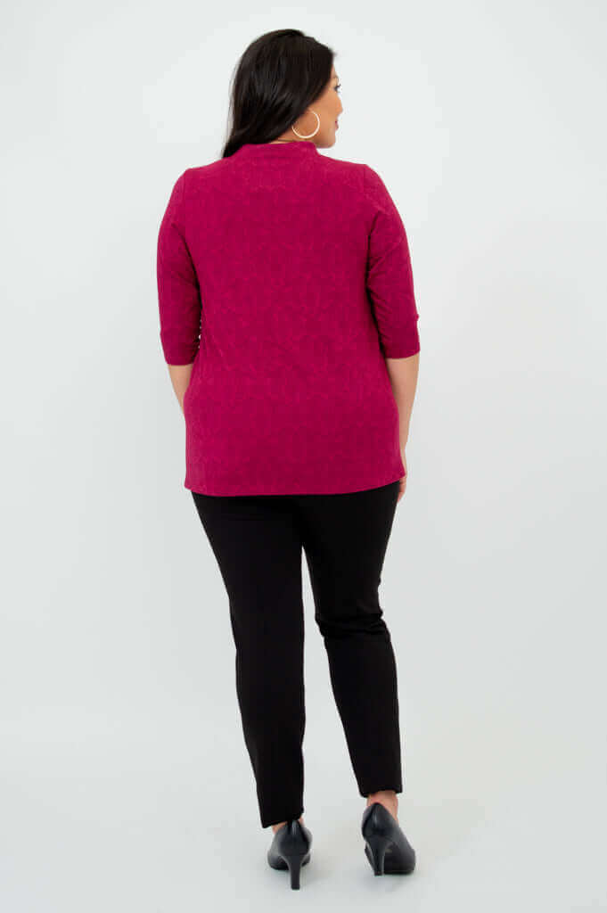 Back view of woman modeling raspberry V-neck bamboo top and black pants