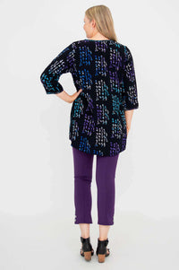 Back view of woman wearing black batik blouse with colorful patterns