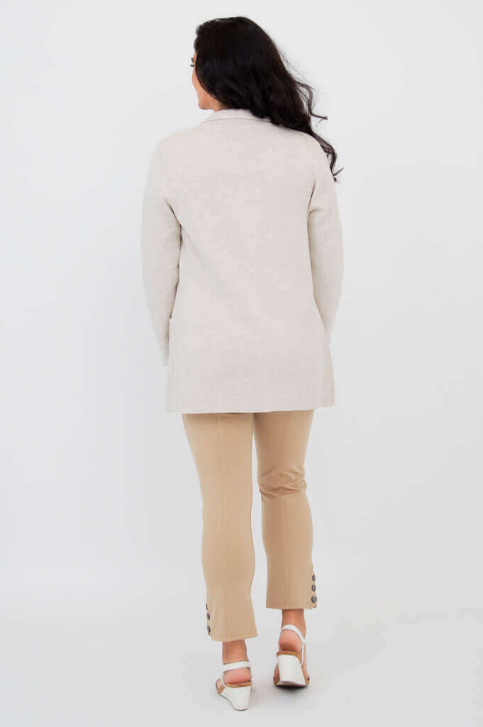 Back view of the Margaret beige cardigan sweater worn by a woman