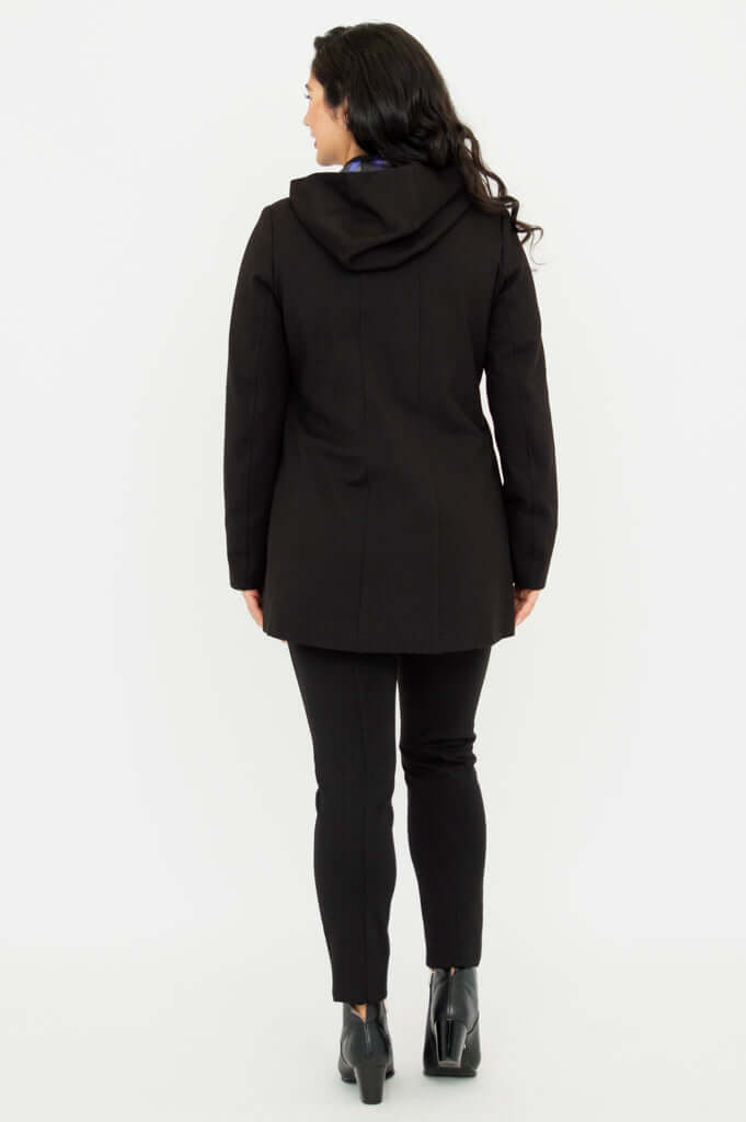 Back view of model wearing The Highlands Coat with hood down