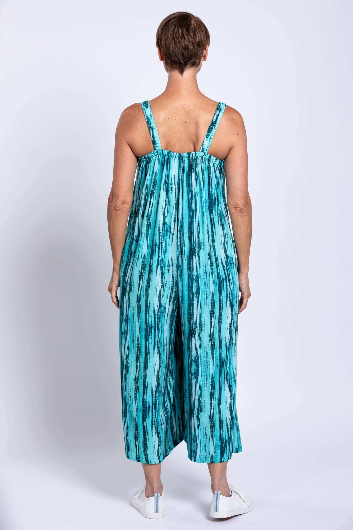 Back view of woman in aqua blue sleeveless jumpsuit