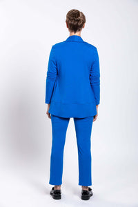 Back view of woman wearing a bright blue French Terry jacket and pants