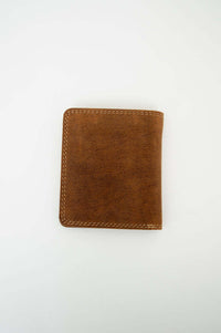 Back view of a brown leather bifold wallet on white background